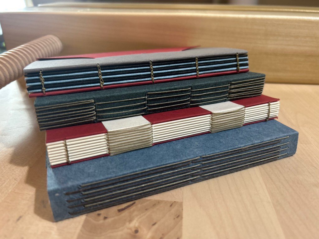 Four different examples of exposed sewing bindings in a stack.