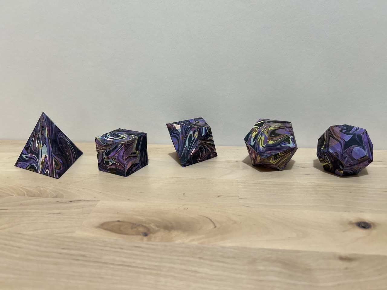 plutonic solids made of cosmic overmarbled paper. 